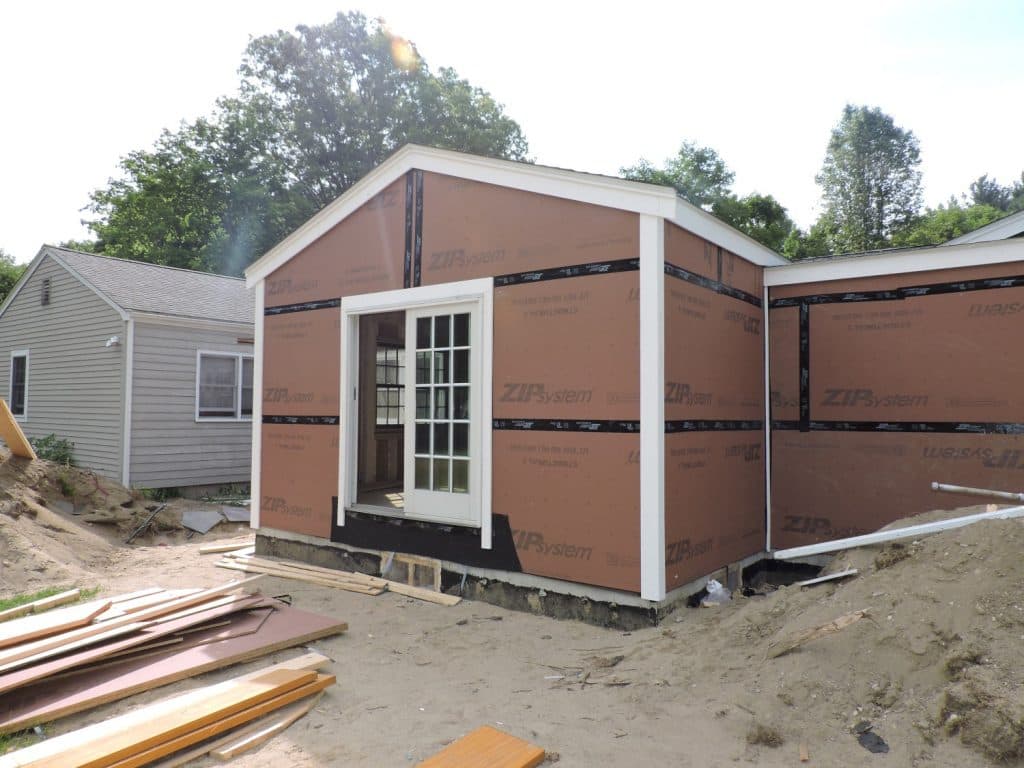Single-story home addition sheathed and wrapped, during construction
