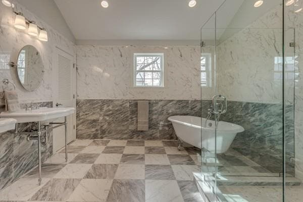 Marble bathroom with clawfoot tub, checkerboard floor and glass shower